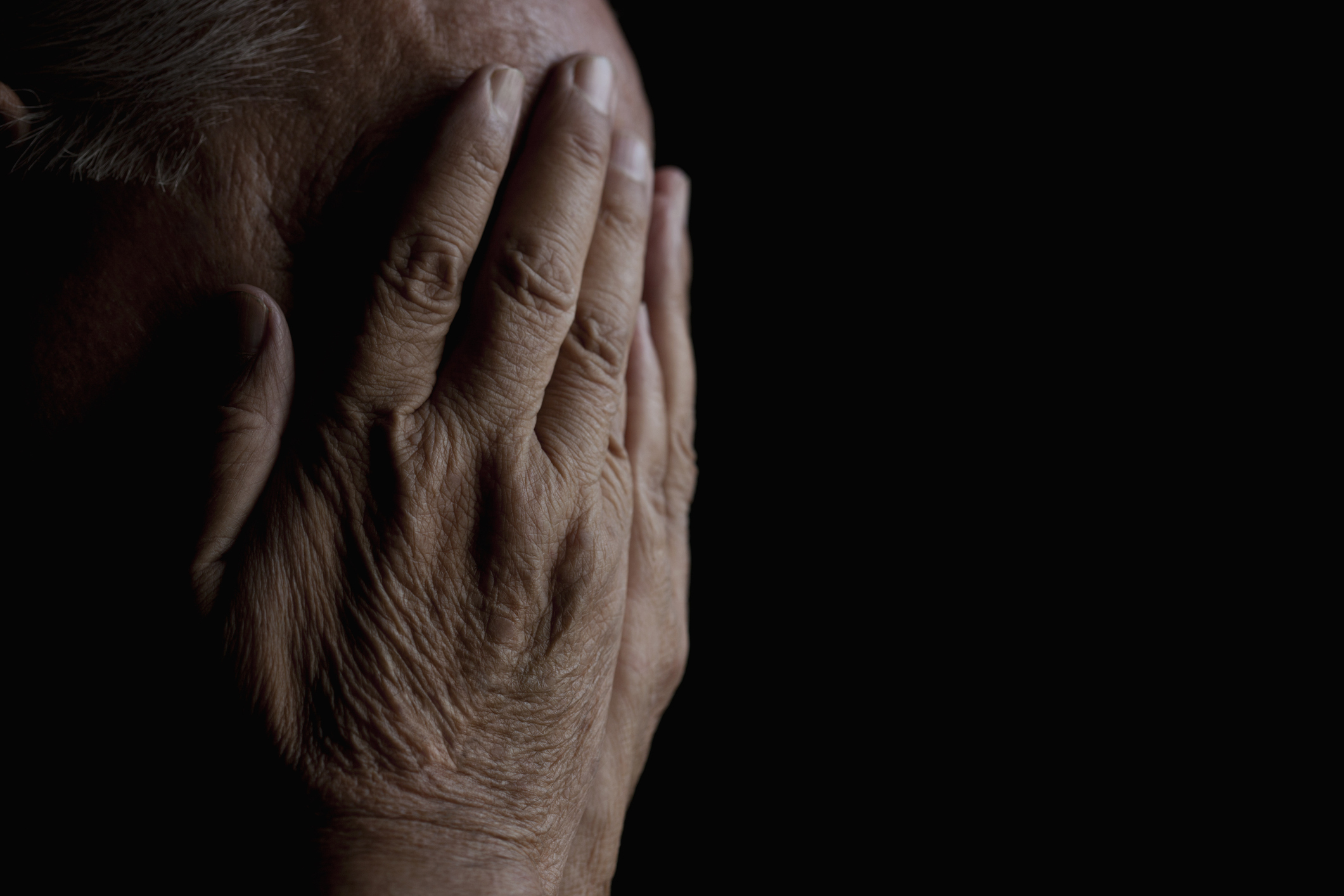 Person with hands covering face, signifying distress or deep contemplation. Image is suited for an article about parenting challenges or emotions