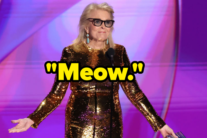 Candice Bergen on stage in a shiny, long-sleeve dress, wearing glasses and turquoise earrings, with the word "Meow." in large yellow text superimposed over the image