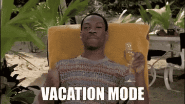Eddie Murphy relaxes on a beach lounge chair, holding a drink, with "VACATION MODE" text over the image