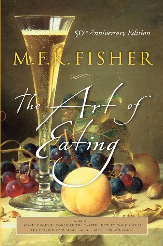 Cover of the 50th Anniversary Edition of "The Art of Eating" by M.F.K. Fisher with a glass of champagne and an arrangement of fruits