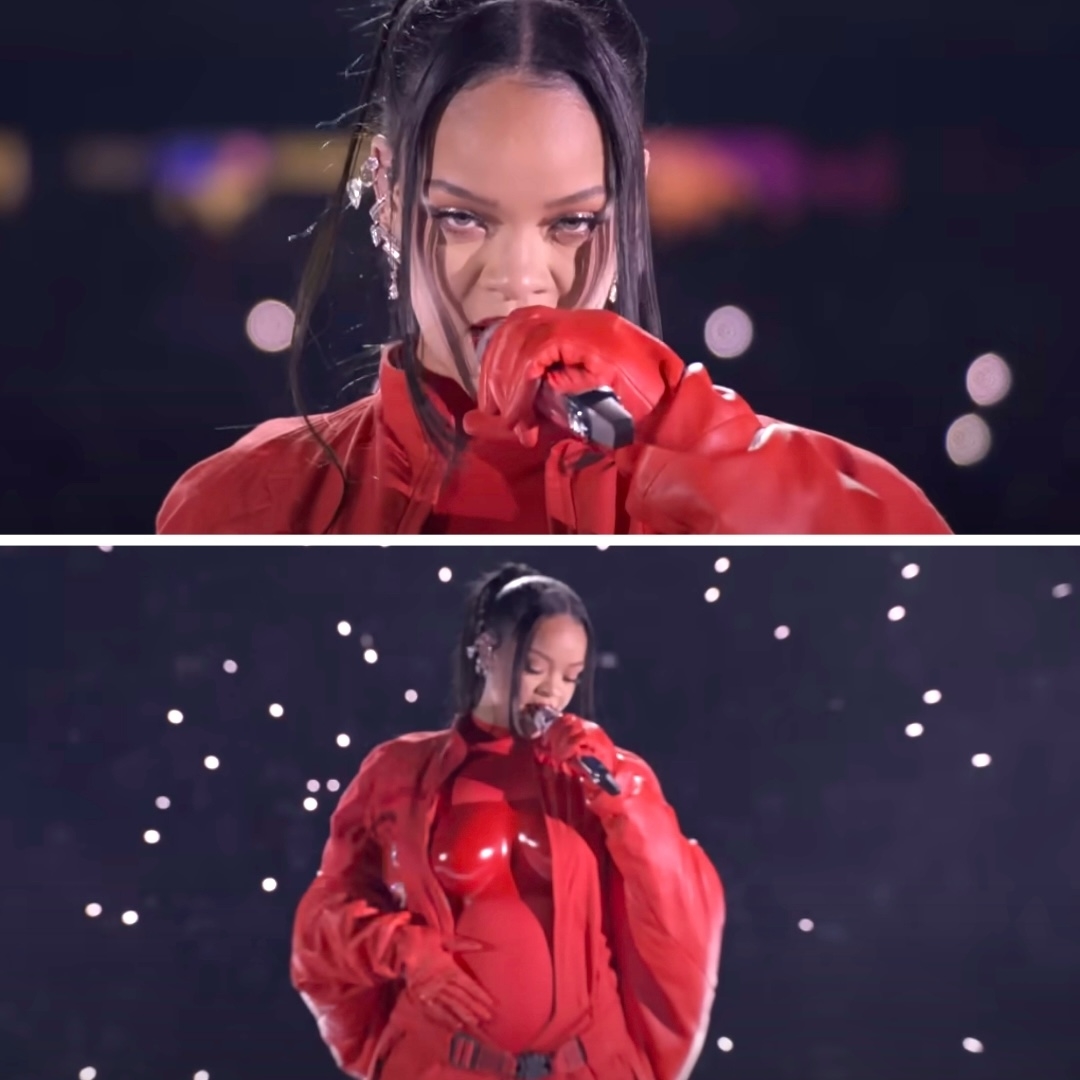 Rihanna performing on stage wearing a shiny red outfit and red gloves, holding a microphone, with her hair styled in a high ponytail