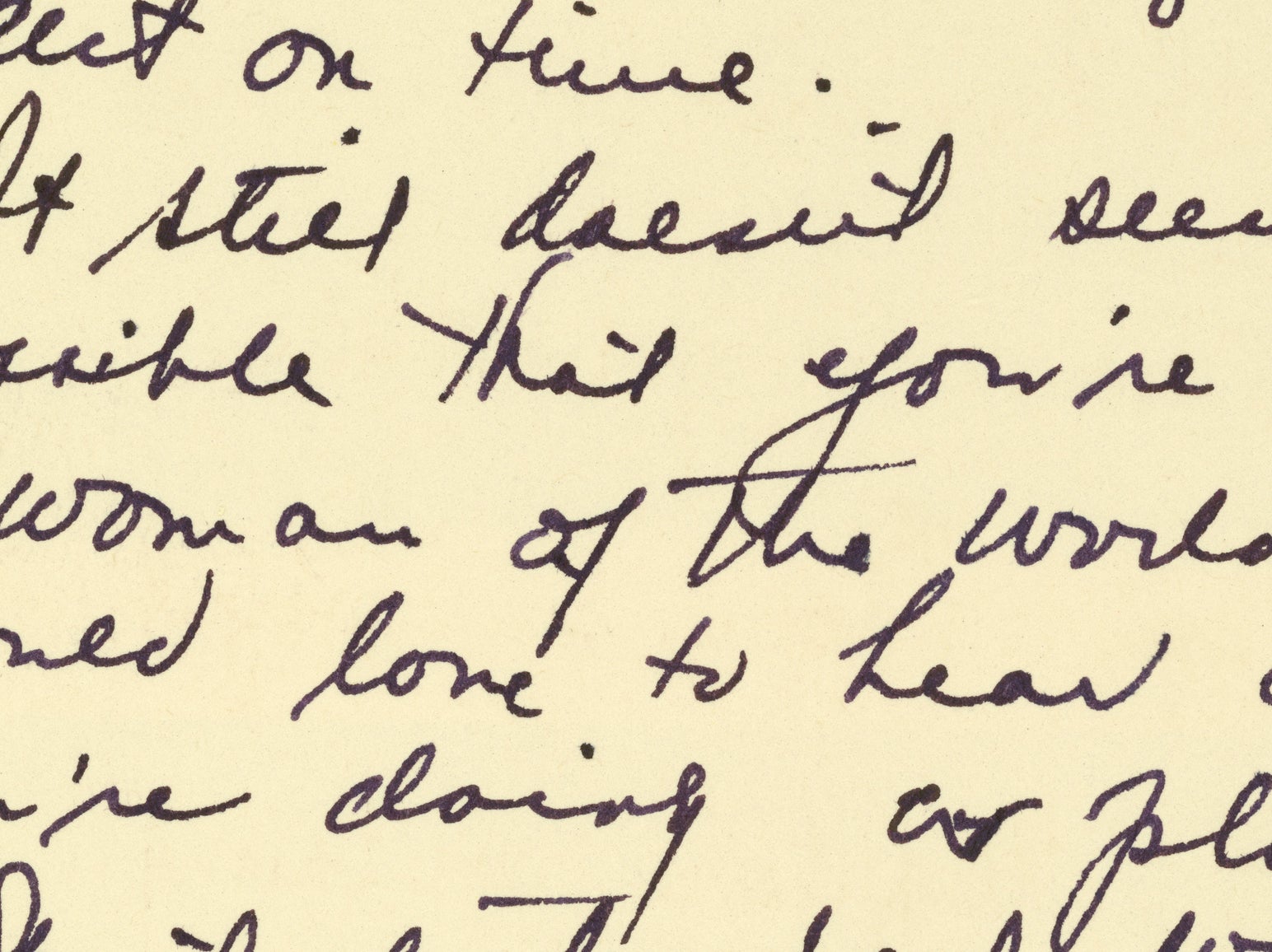 Handwritten text in cursive on a yellow background, difficult to read individual words. The text appears to be a letter or note. Content is not fully legible