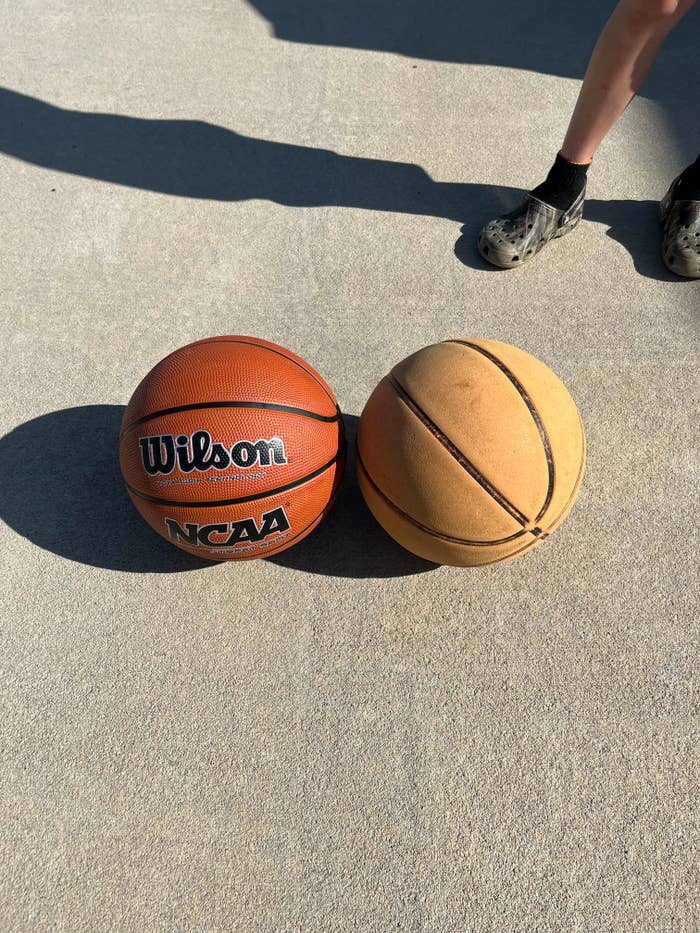 Two basketballs side by side on concrete. The left one is marked "Wilson NCAA." Partial view of a person's legs wearing black Crocs