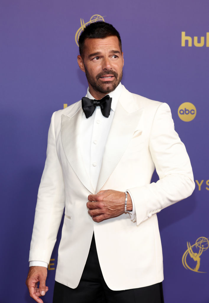 Ricky Martin on the red carpet wearing a tuxedo jacket, shirt, and bow tie