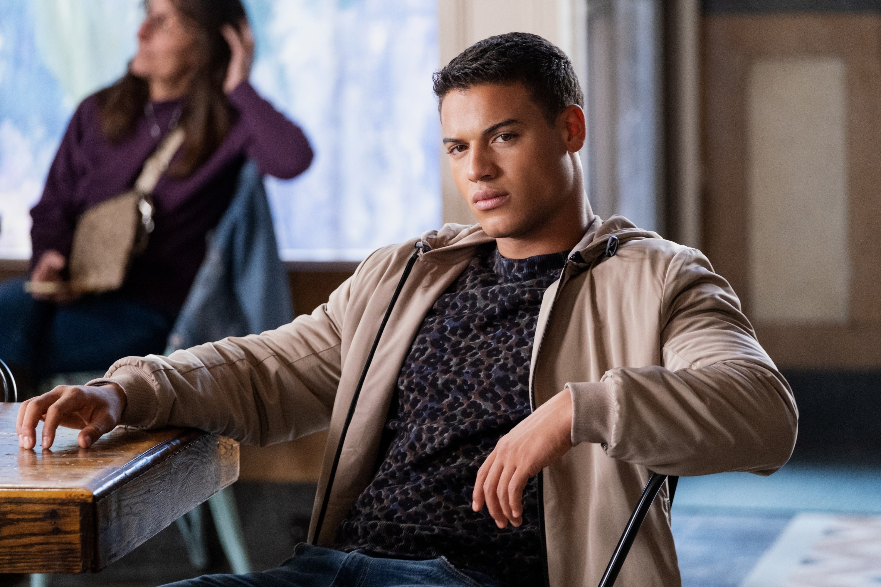 Jan Luis Castellanos in casual clothing, sitting at a desk in "13 Reasons Why"