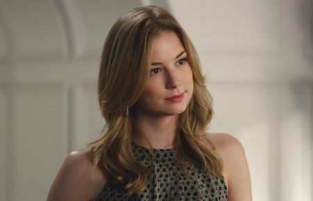 Emily VanCamp is gazing off-camera with a slight smile, wearing a sleeveless patterned top