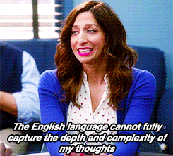 Chelsea Peretti, with long wavy hair and a blue cardigan, saying, &quot;The English language cannot fully capture the depth and complexity of my thoughts.&quot;