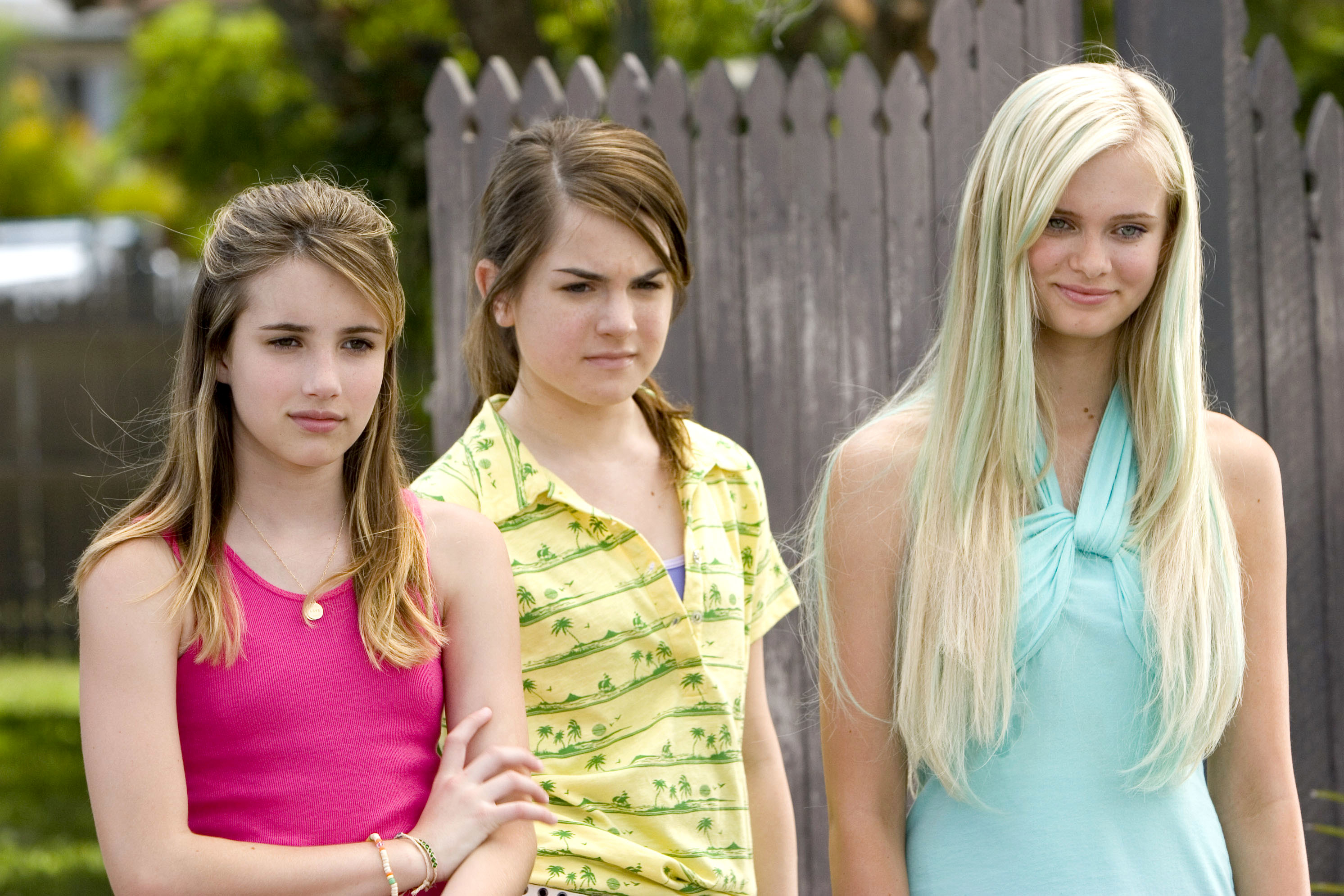 Emma Roberts, Jojo Wright, and Sara Paxton stand together outdoors in casual attire