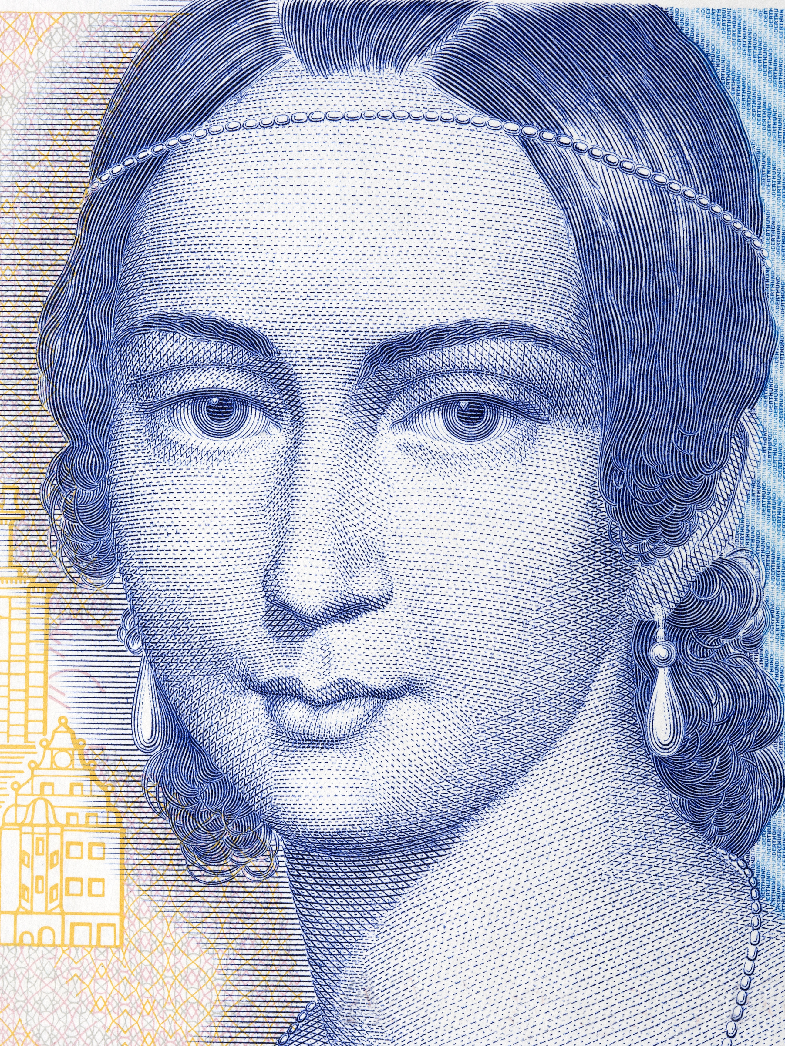 A detailed portrait of Clara Schumann wearing drop earrings, featured on currency