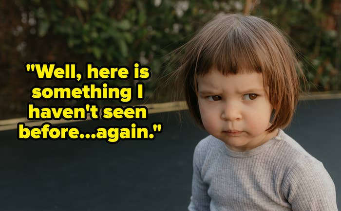 A young child on a trampoline, looking serious with a slightly furrowed brow