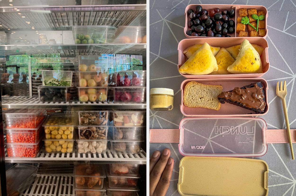 A packed refrigerator with various fruits and snacks on the left. On the right, an open pink lunchbox contains grapes, other fruits, sandwiches, and spreads