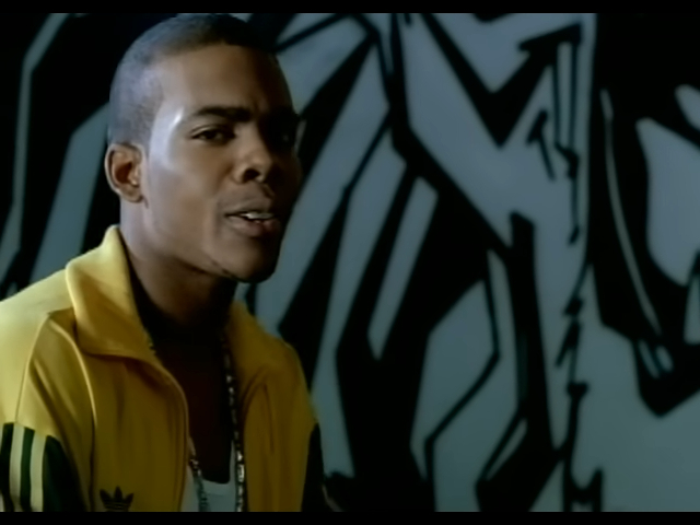 Mario in a yellow jacket against a graffiti-style background