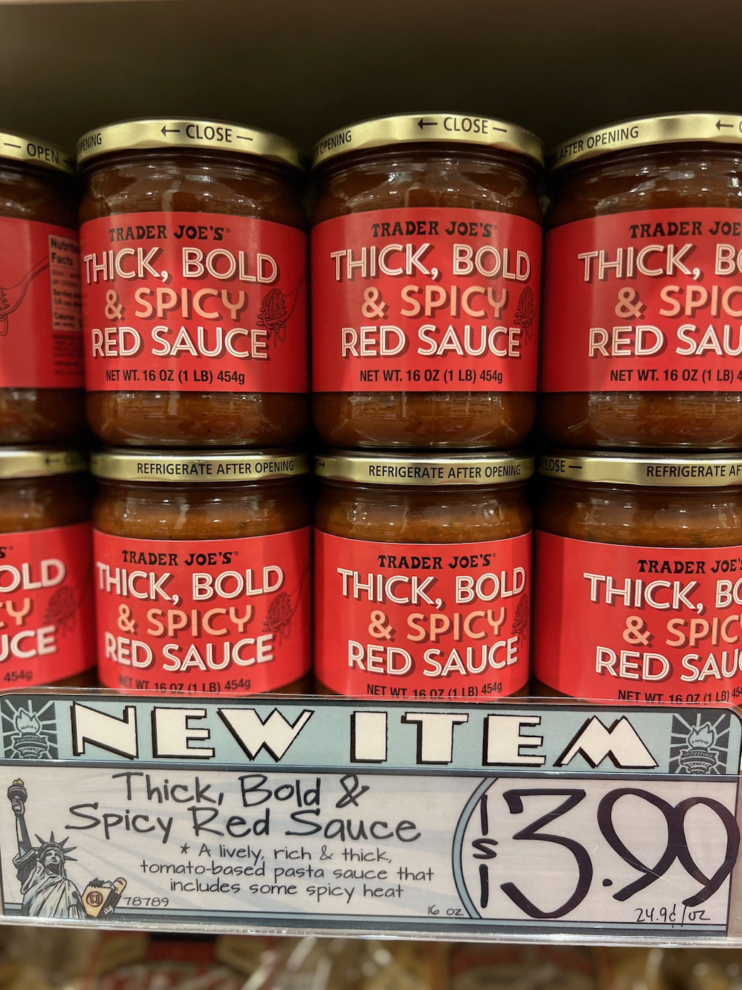 Trader Joe's Thick, Bold, &amp;amp; Spicy Red Sauce jars are displayed with a price tag of $3.99 each and a description highlighting the sauce's spicy heat