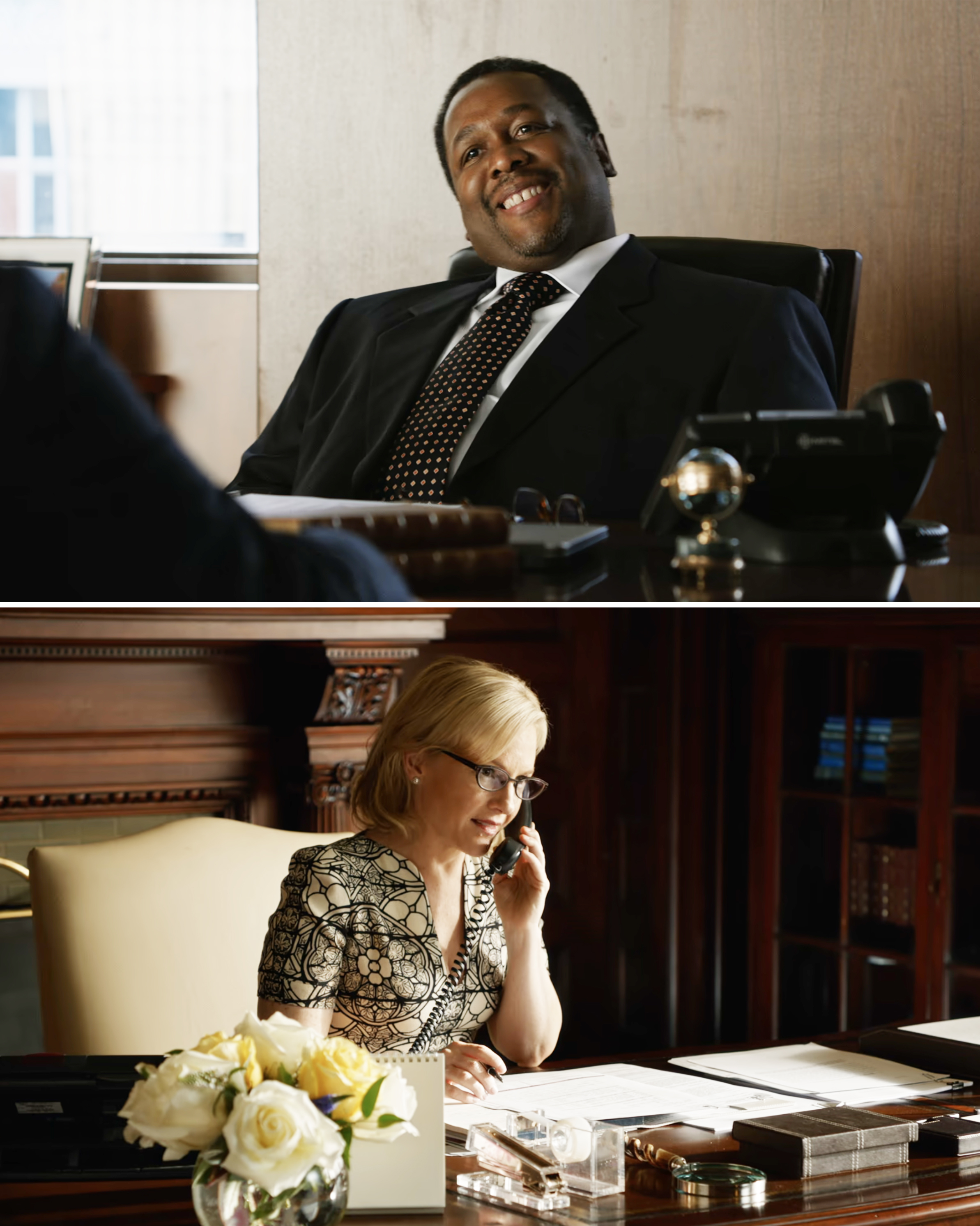Wendell Pierce, in a suit and tie, smiling behind a desk in an office; Rachael Harris, in a patterned dress, on the phone behind a desk with yellow roses