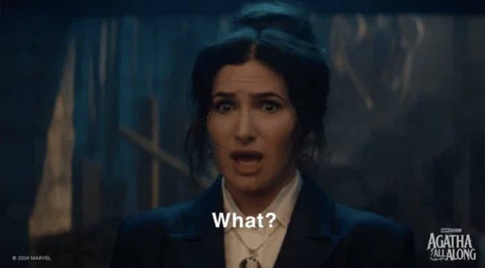 Kathryn Hahn as Agatha Harkness in Marvel's "Agatha All Along" looks surprised and says, "What?"