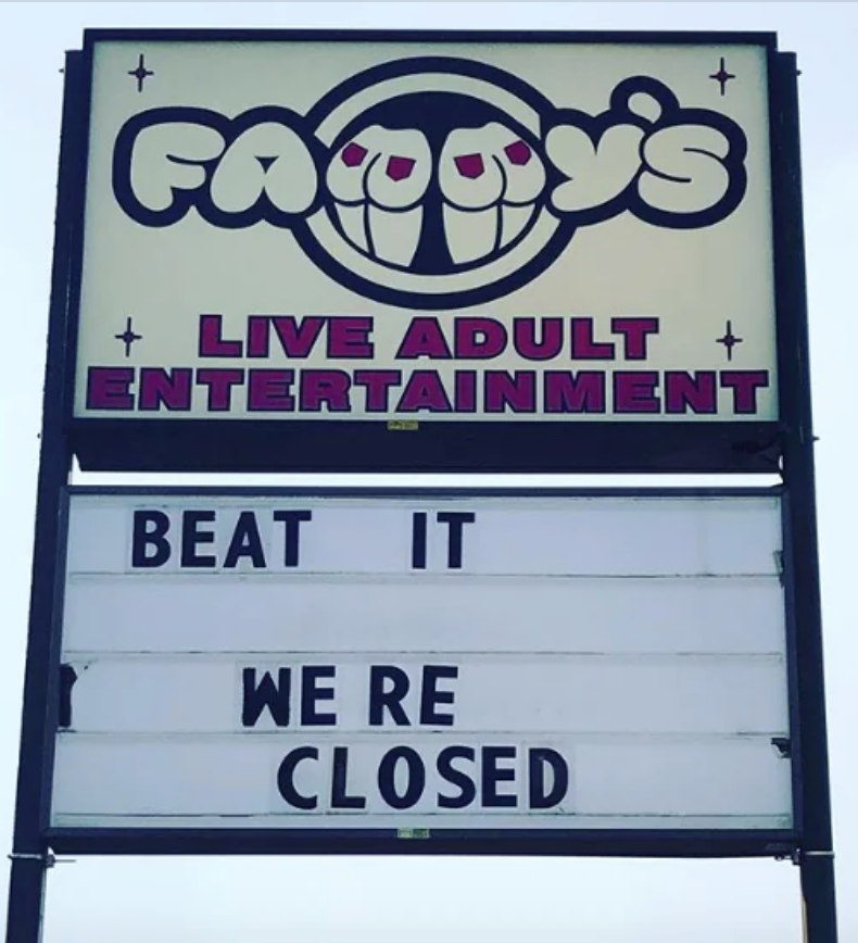 Sign for "Fuzzy's Live Adult Entertainment" with the message "BEAT IT WE'RE CLOSED" below it