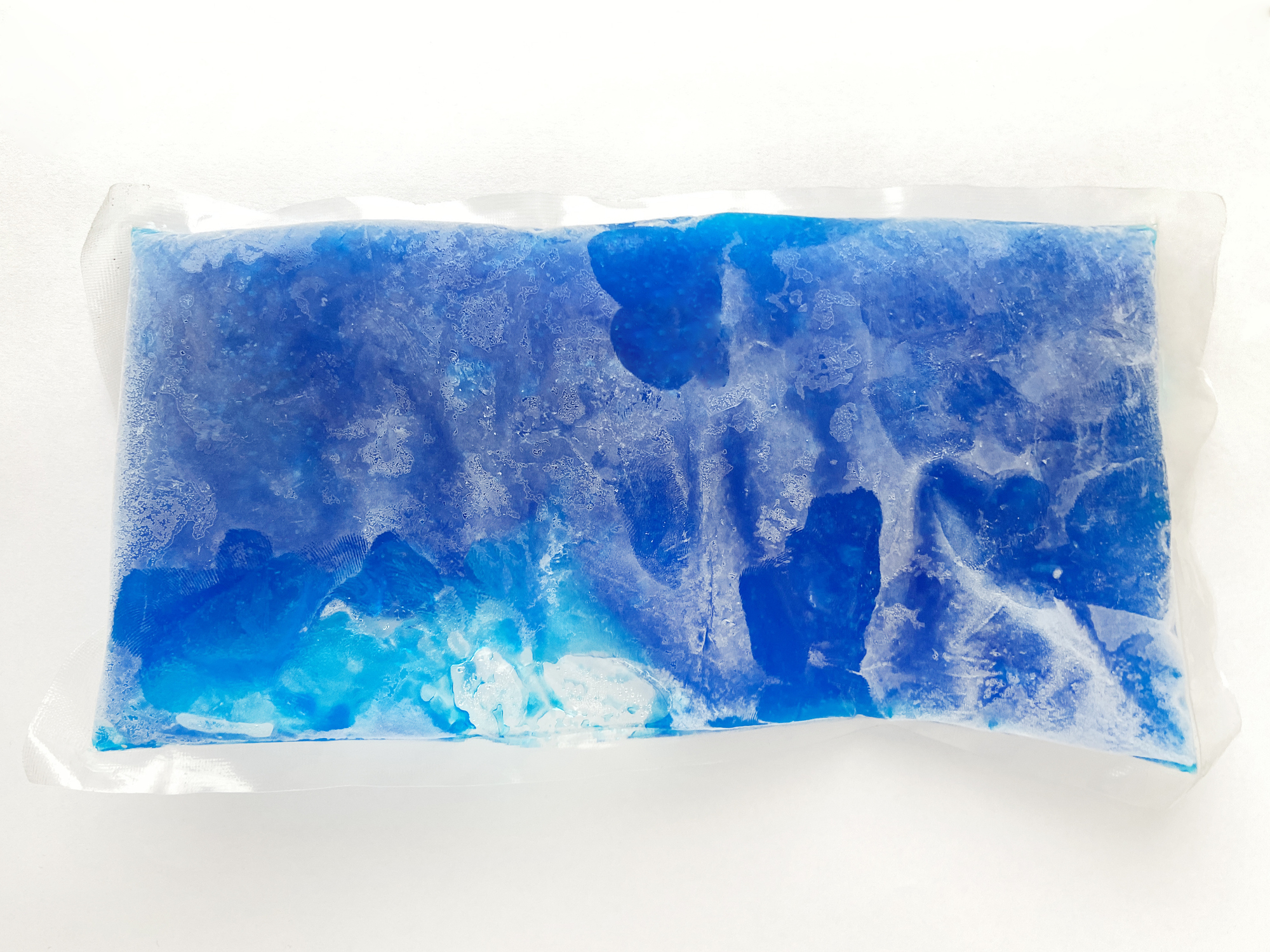 A reusable blue gel ice pack in a clear plastic cover