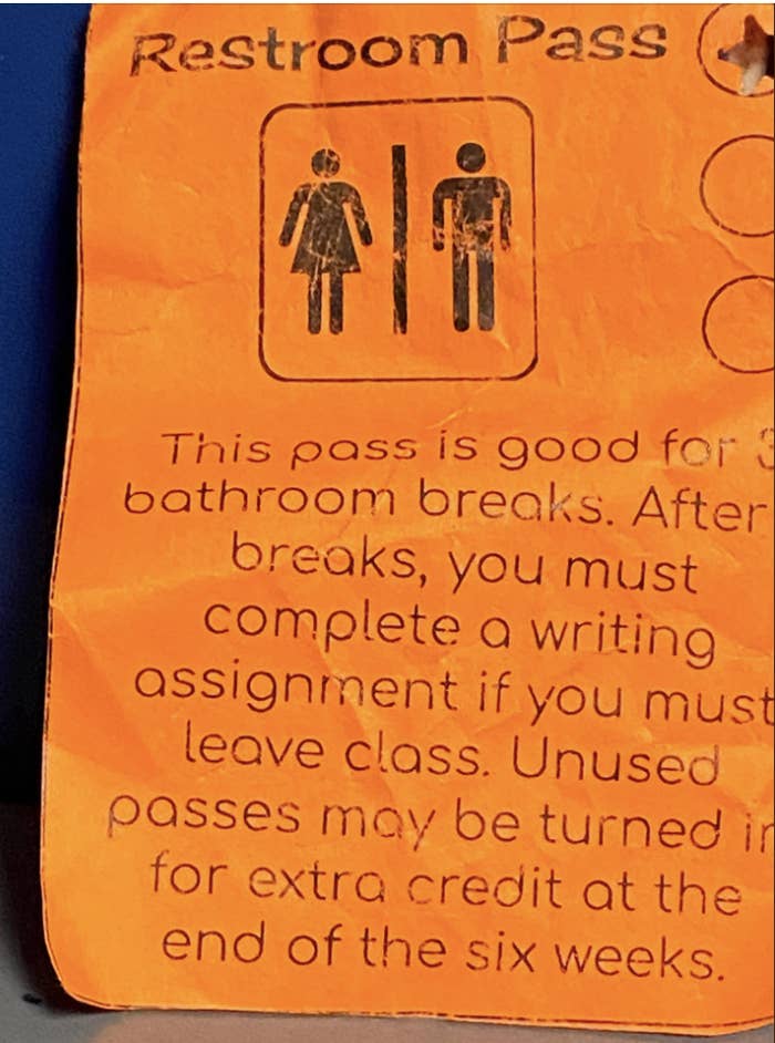Restroom pass stating it can be used for bathroom breaks. Requires a writing assignment if used to leave class. Unused passes offer extra credit