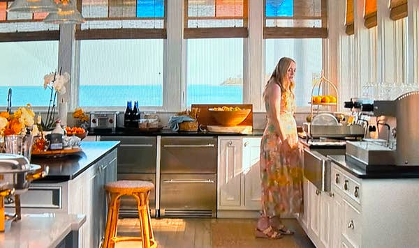 Abby stands over the kitchen sink in Netflix&#x27;s &quot;The Perfect Couple&quot;