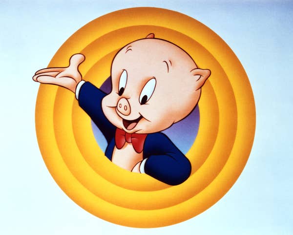 Porky Pig, an animated character, is seen in a classic end scene pose with his arm raised, wearing a suit and bow tie, in a concentric circle backdrop