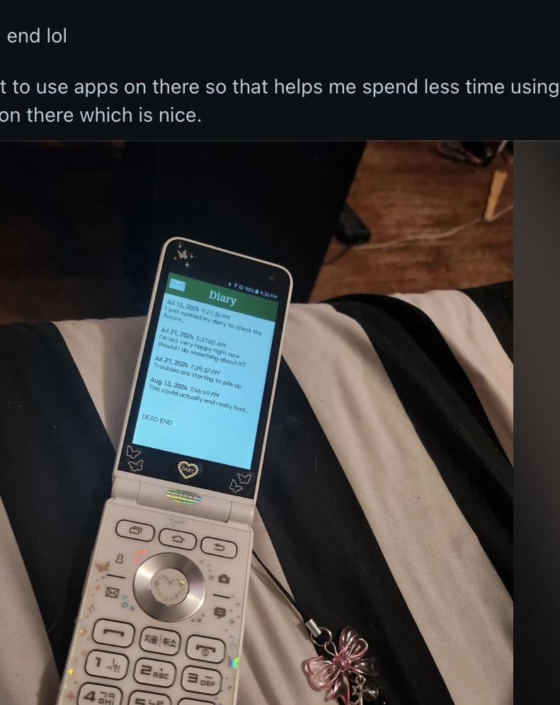Reddit post showing a flip phone with large buttons and screen on a cloth surface. The post discusses the user's first time using a flip phone in years and their view on modern smartphones