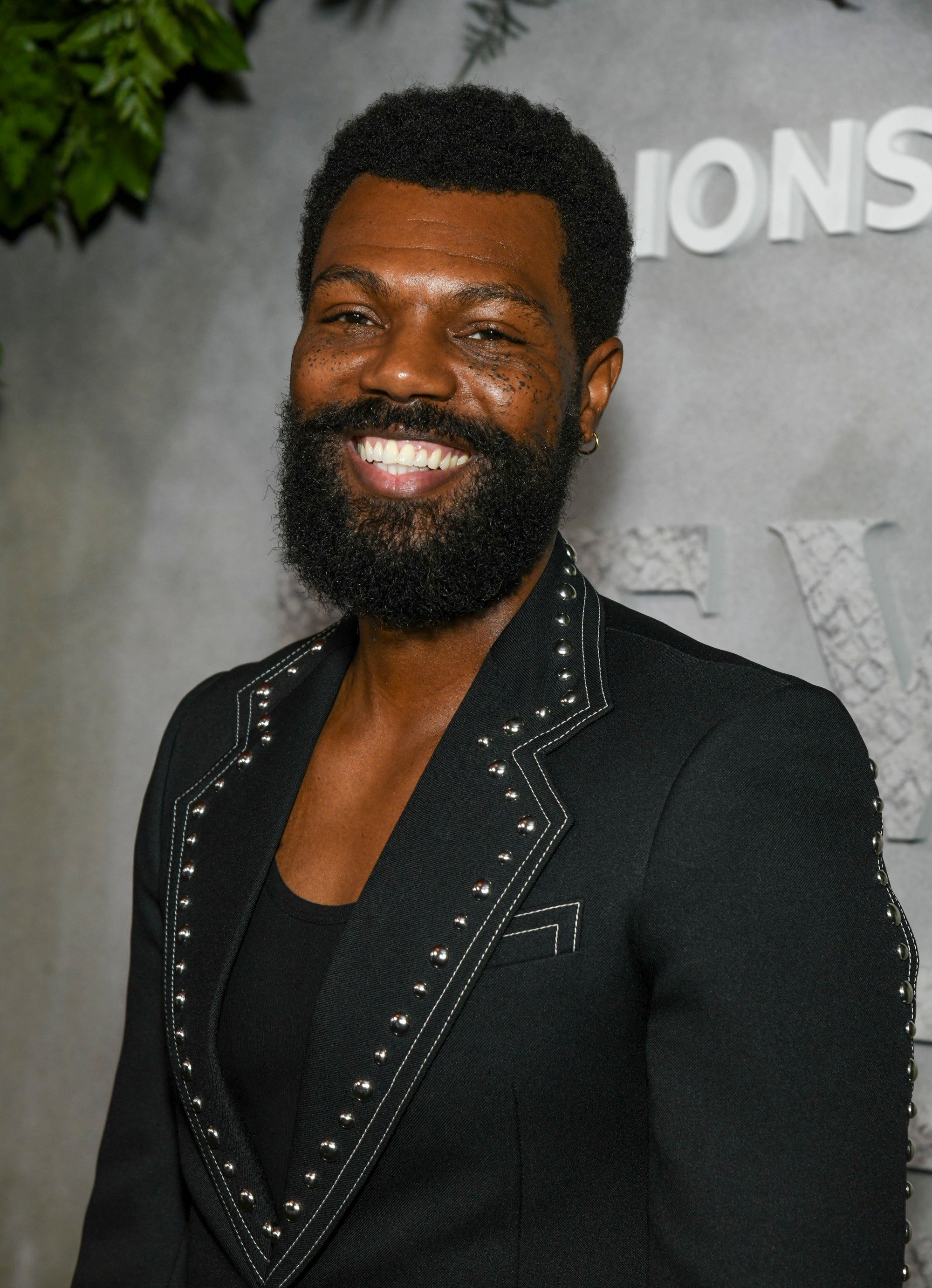 William Catlett in a black suit with intricate details on the red carpet for "Never Let Go"