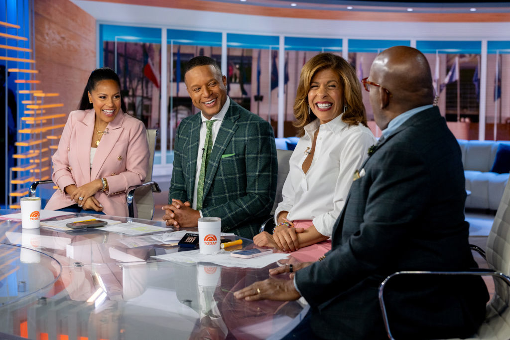 Sheinelle Jones, Craig Melvin, Hoda Kotb, and Al Roker are sitting at a news desk, smiling and talking during a broadcast