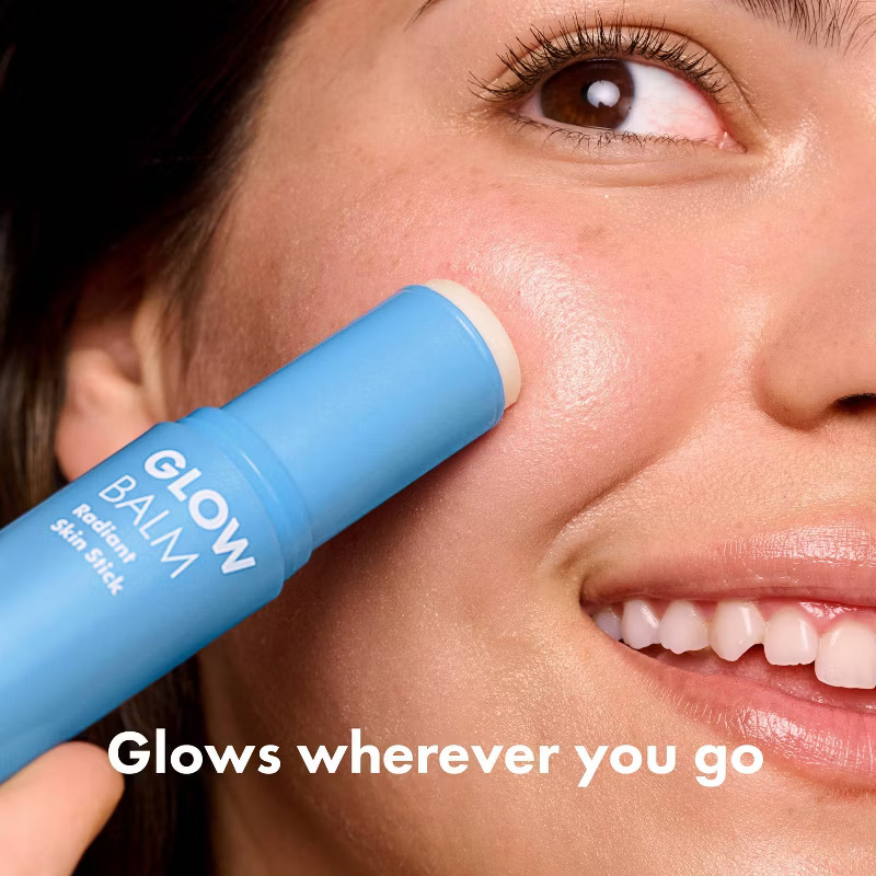 Model applying the glow balm with text reading "glows wherever you go"