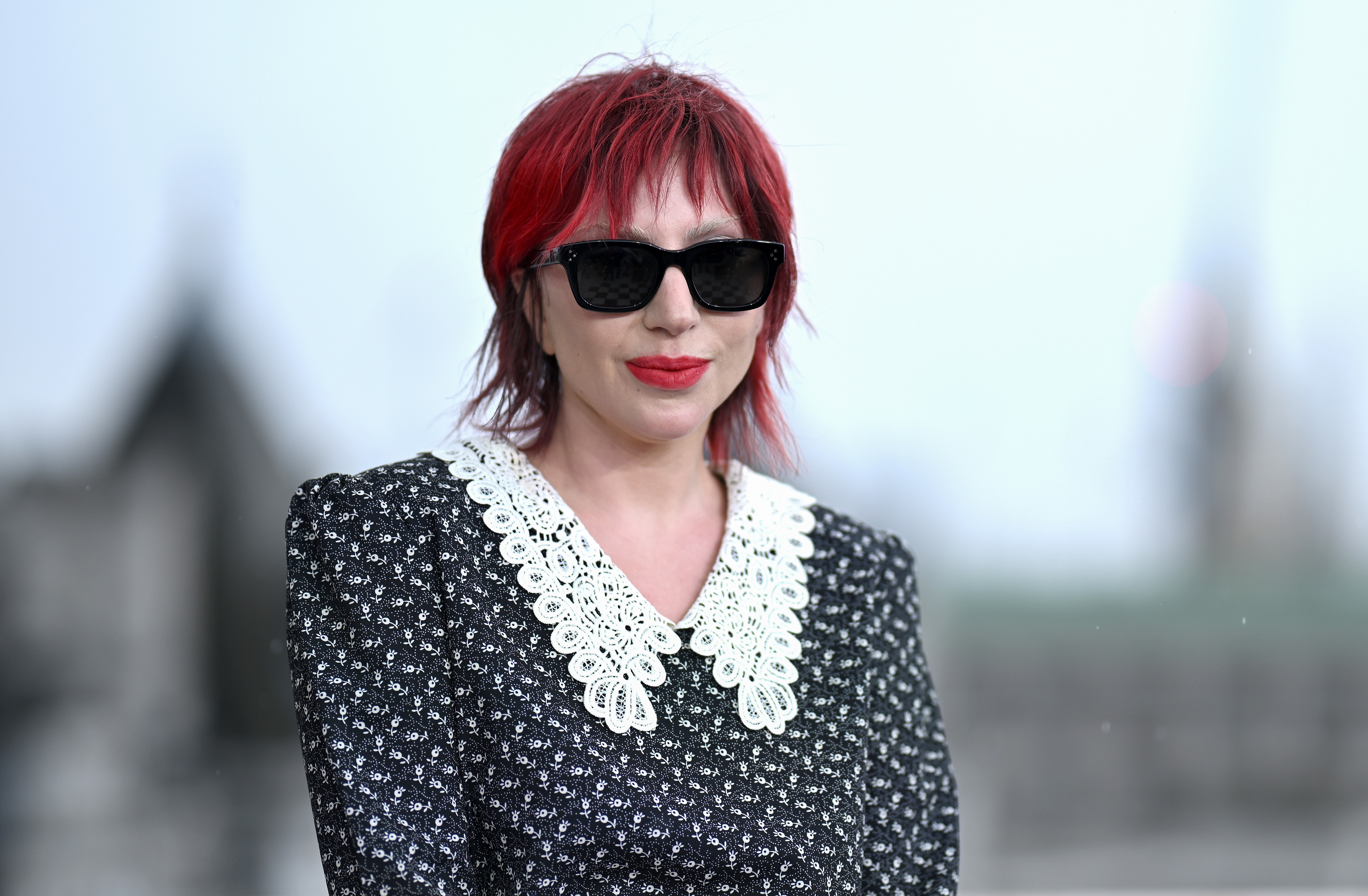 Lady Gaga in a patterned dress with a lace collar and sunglasses