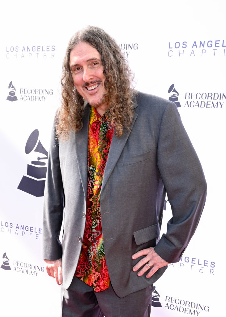 &quot;Weird Al&quot; Yankovic smiles for a photo at the Los Angeles Recording Academy event, wearing a colorful shirt and a gray suit