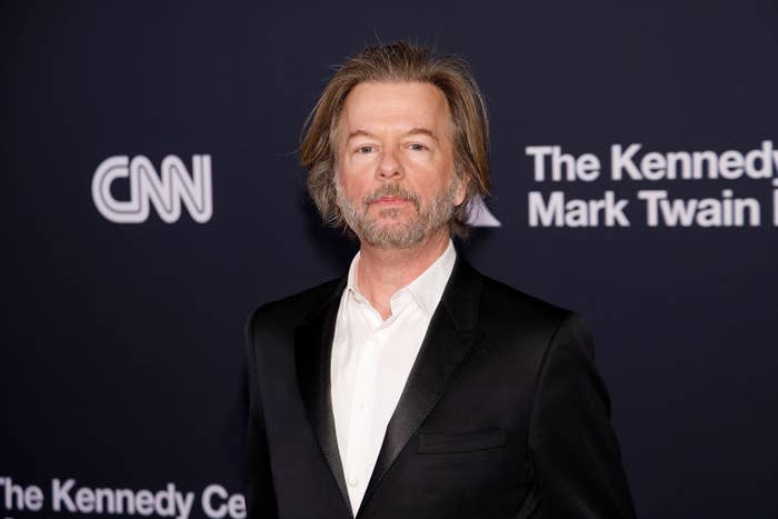 David Spade in a dark suit and shirt at The Kennedy Center Mark Twain Prize event