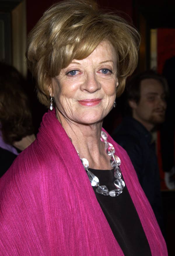 Maggie Smith poses for a photo, wearing a statement necklace and a shawl