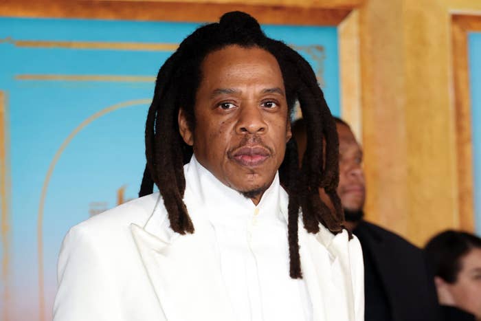 Jay-Z in a white suit attends an event