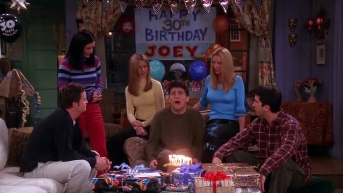Courteney Cox, Jennifer Aniston, Lisa Kudrow, Matt LeBlanc, David Schwimmer, and Matthew Perry celebrate Joey’s 30th birthday with a cake and gifts