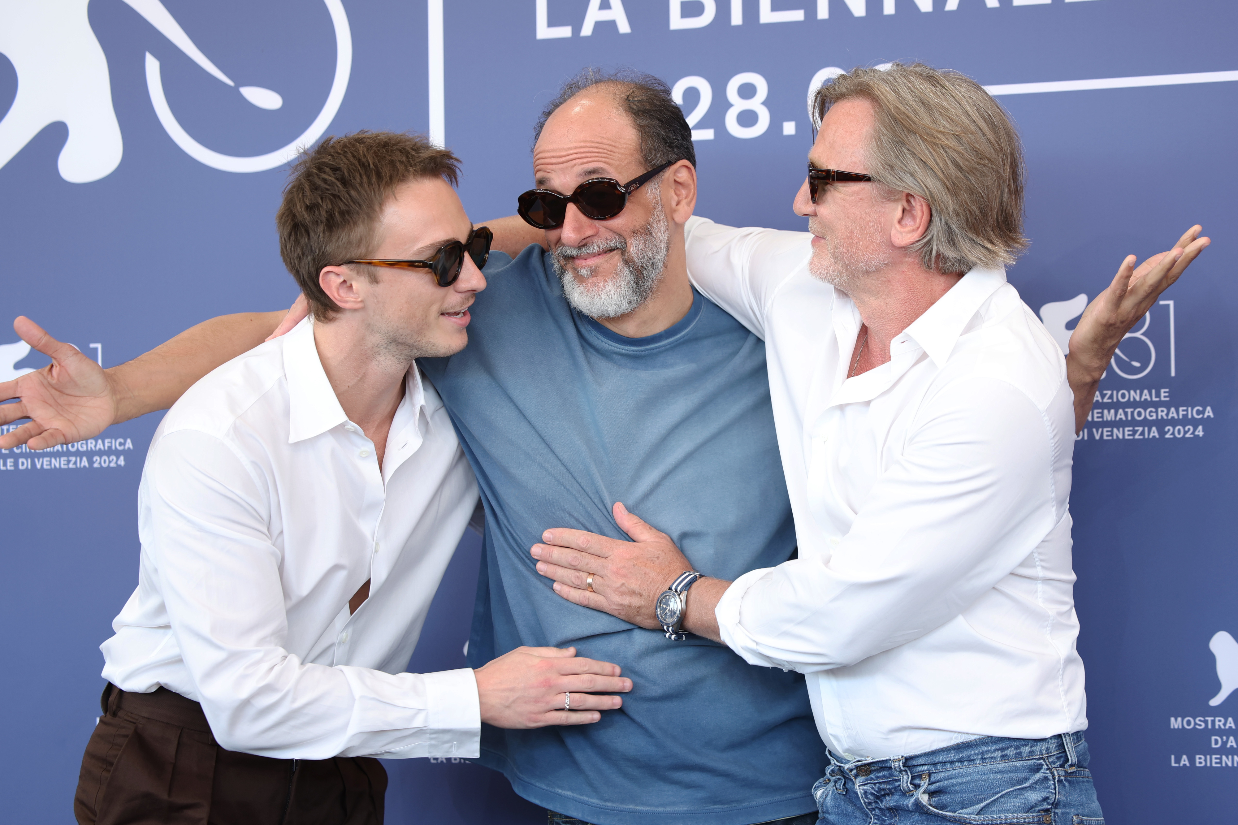 Drew Starkey, Luca Guadagnino, and Daniel Craig share a lighthearted moment at the Venice Film Festival. Guadagnino wears a casual T-shirt, Strong and Mendelsohn in shirts