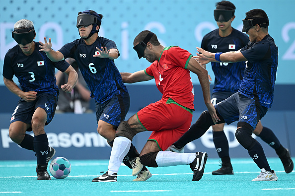 Blind football match at the Paralympics featuring players from Japan (No. 3, 6, 8) and Morocco (No. 4)