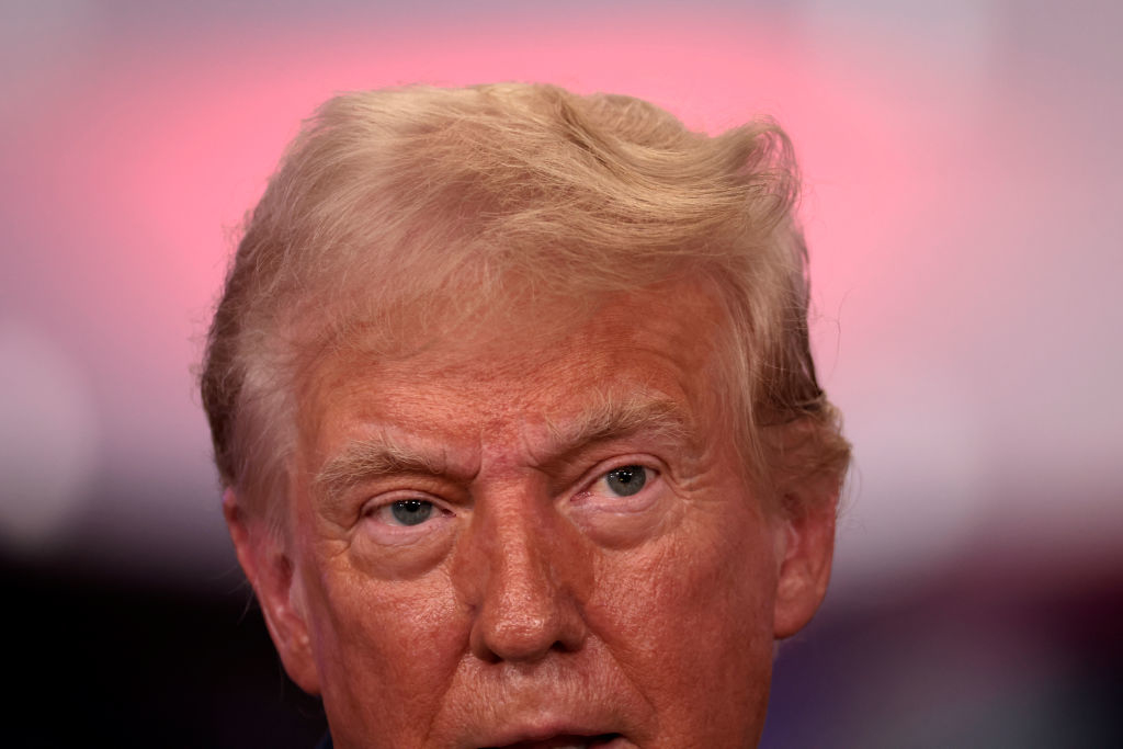 Donald Trump with a serious expression in close-up photo, blurry background