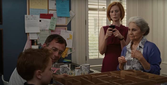 Brian (Steve Carell) helps his son, Jack (Owen Vaccaro), with a project while Rose (Cynthia Nixon) takes a photo and Ester (Diane Keaton) looks on in the background