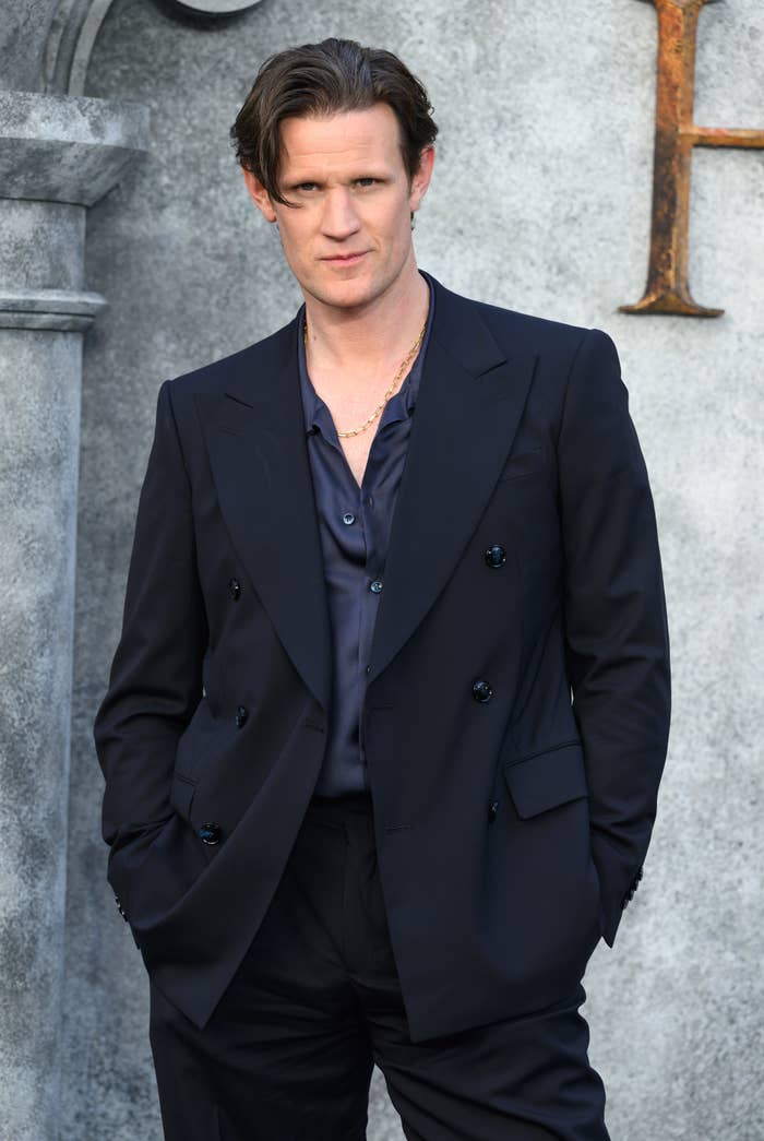 Matt Smith in a double-breasted blazer with a shirt, hands in pockets, at a formal event