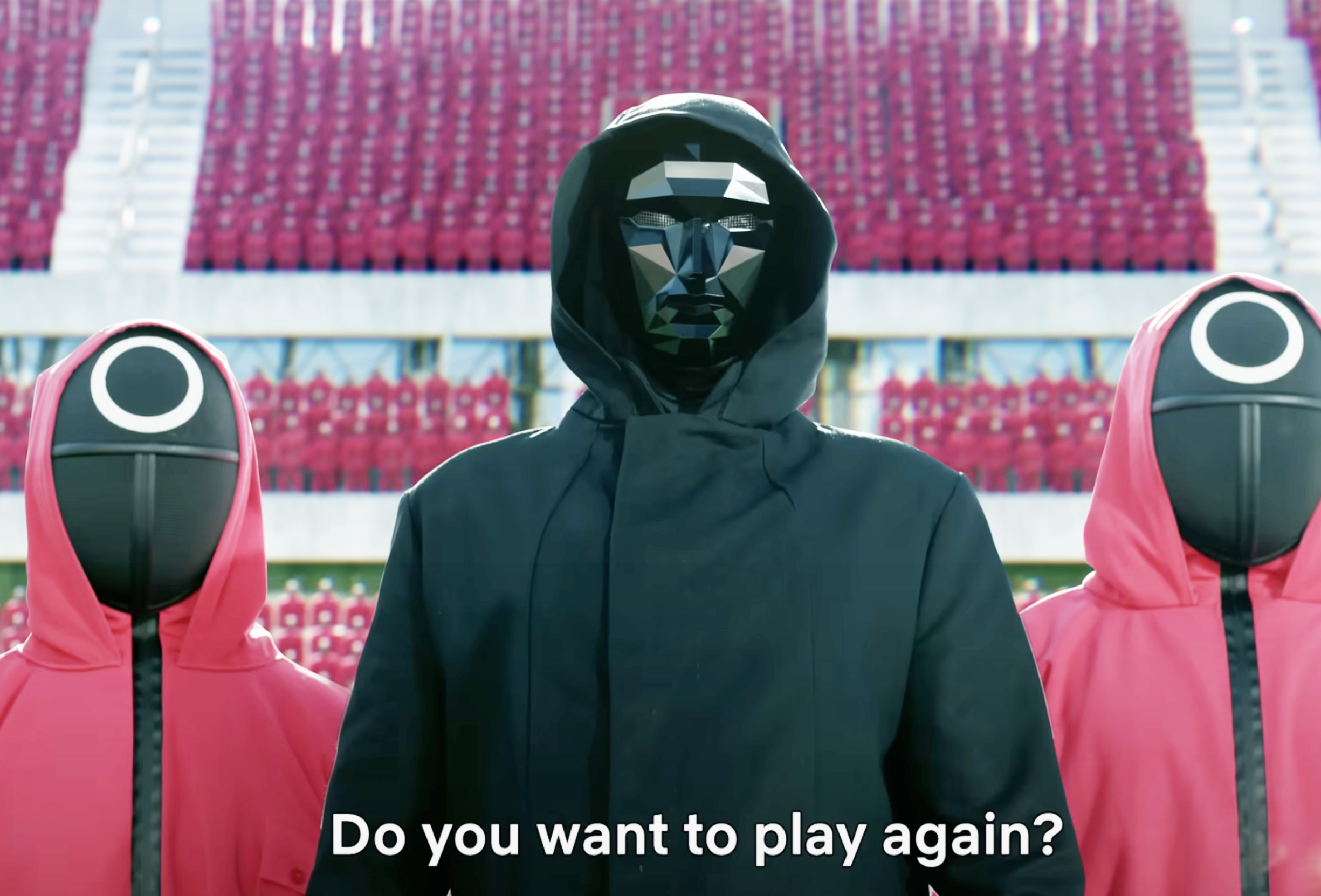 Masked characters from Squid Game in black and pink hooded outfits from "Squid Game," with stadium seats in the background. Subtitle reads: "Do you want to play again?"