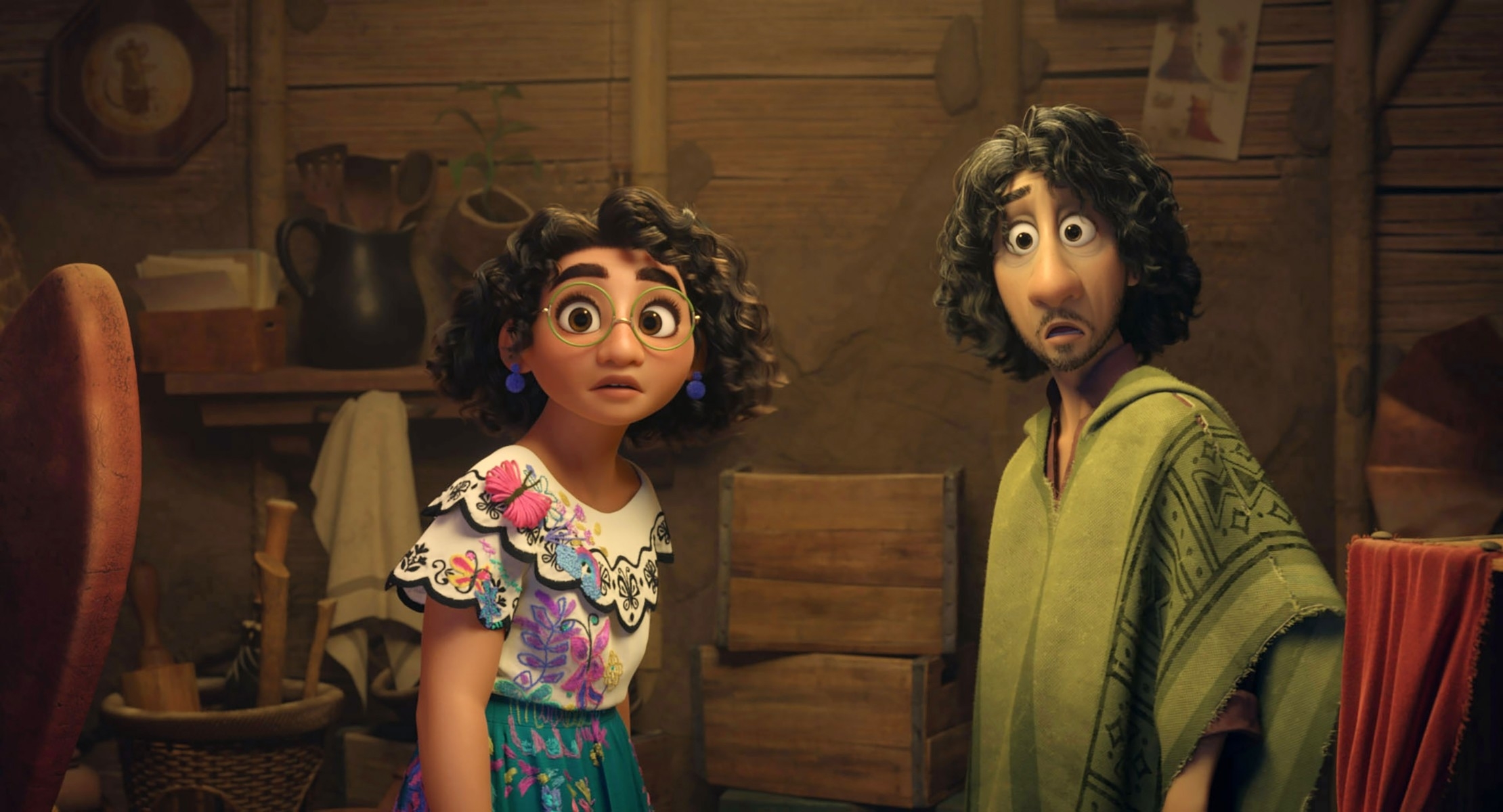 Mirabel and Bruno from Disney's Encanto stand in a rustic room looking surprised