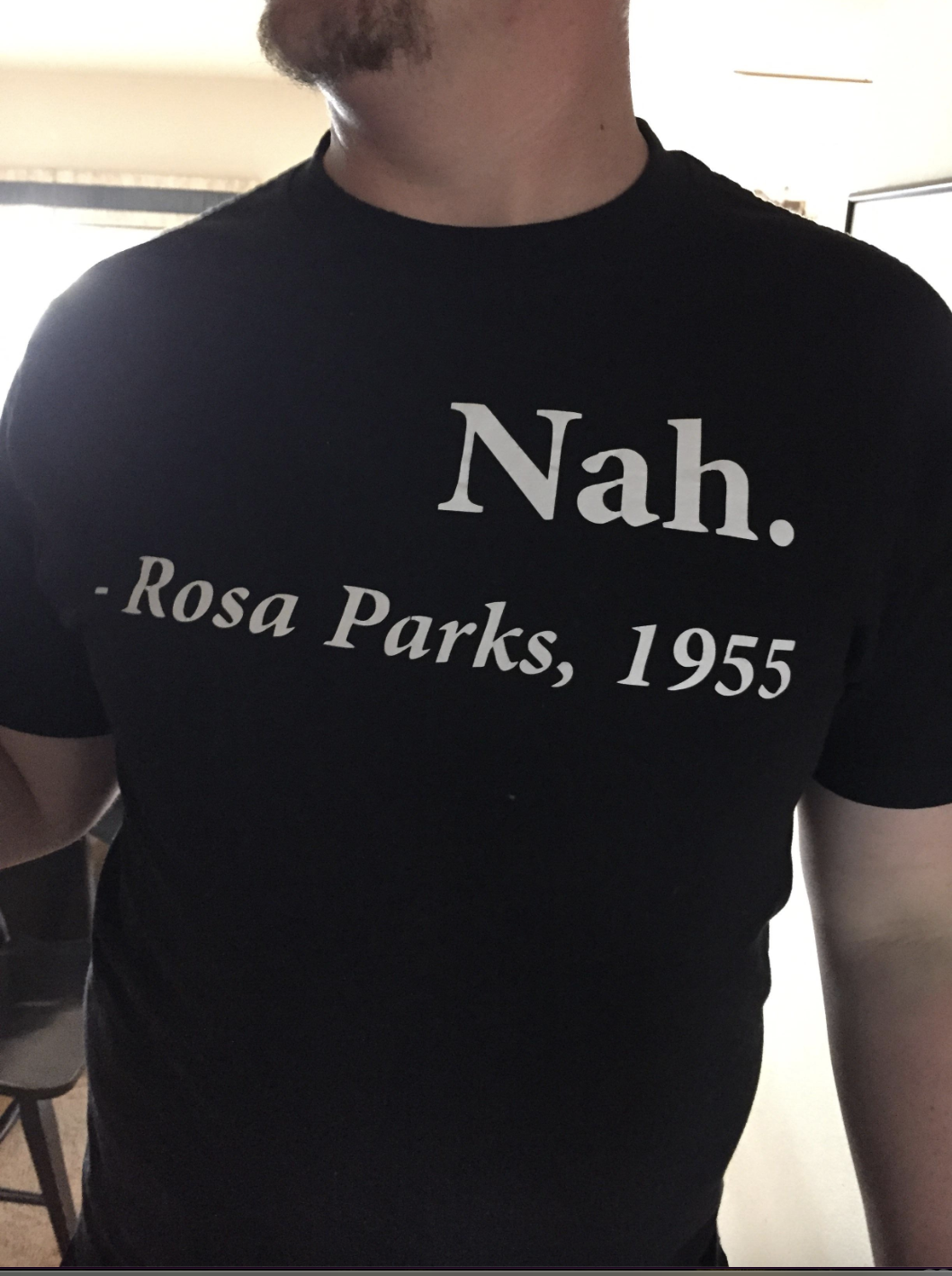 Man wearing a shirt that reads "Nah. - Rosa Parks, 1955"