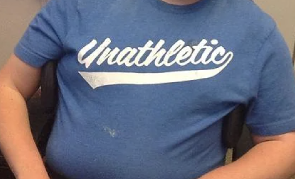 Child wearing a t-shirt that says "Unathletic." Text is in a stylized font