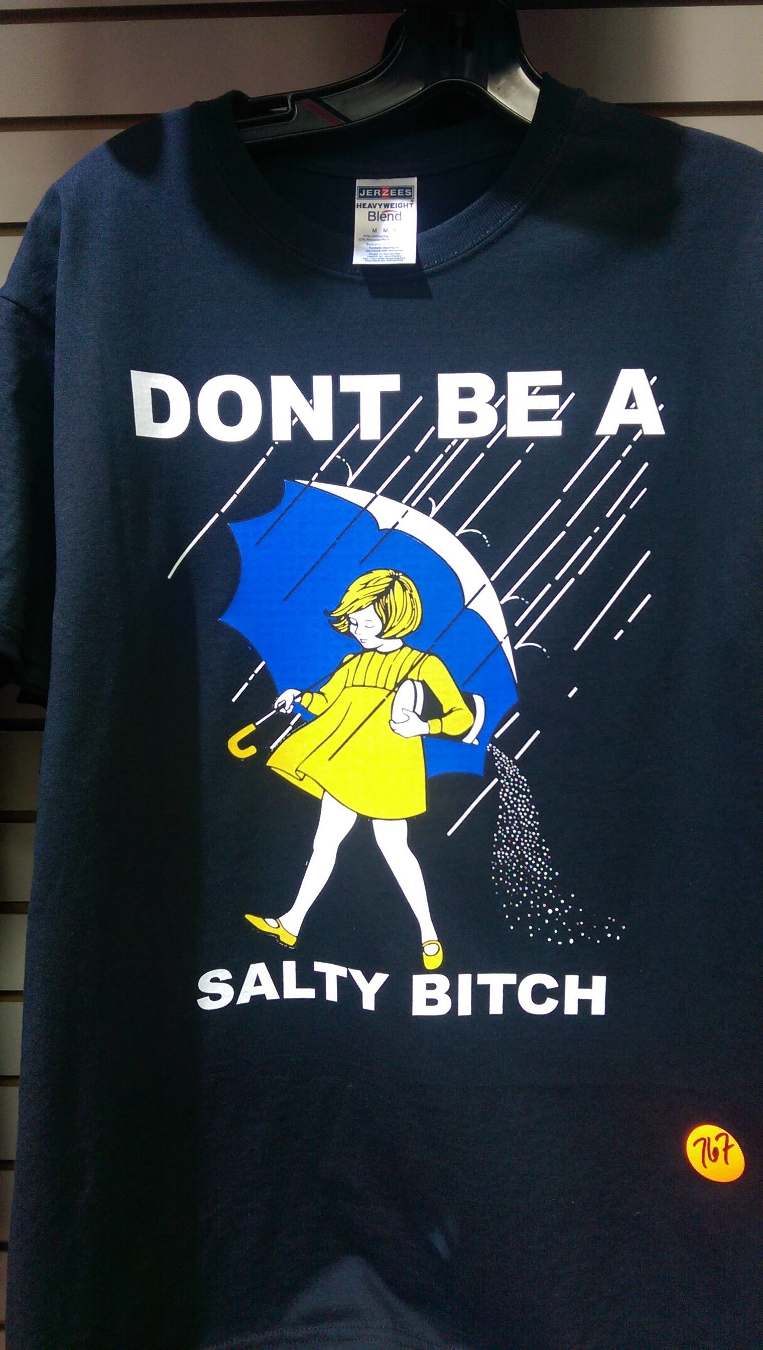 T-shirt featuring a retro-style illustration of a girl with an umbrella and the text "DONT BE A SALTY BITCH" in bold letters