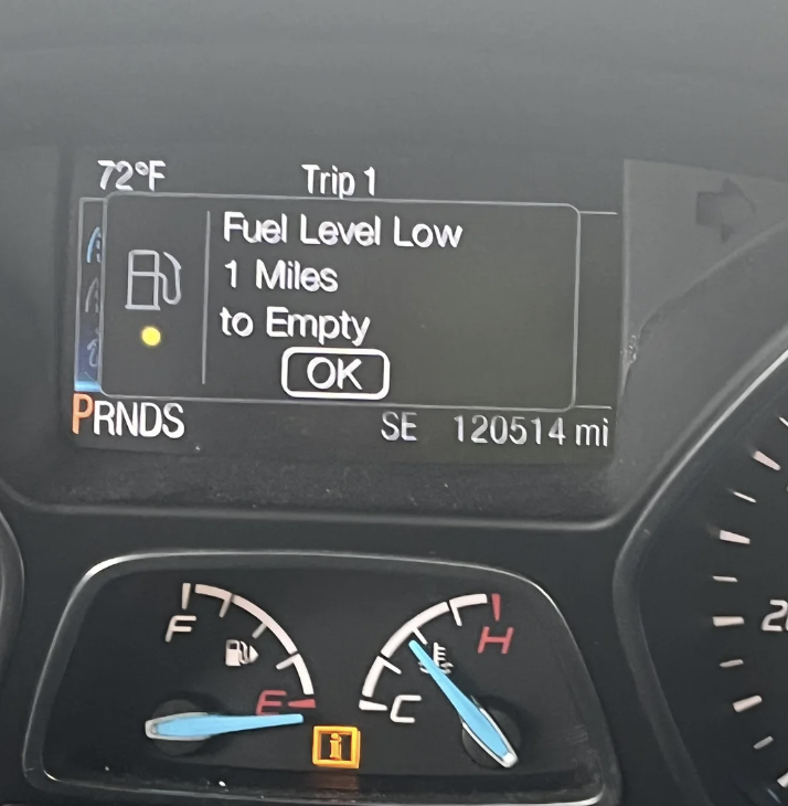 Car dashboard displays 72°F, Fuel Level Low warning, 1 Mile to Empty, Trip 1. 120,514 miles total. Gauge shows nearly empty fuel