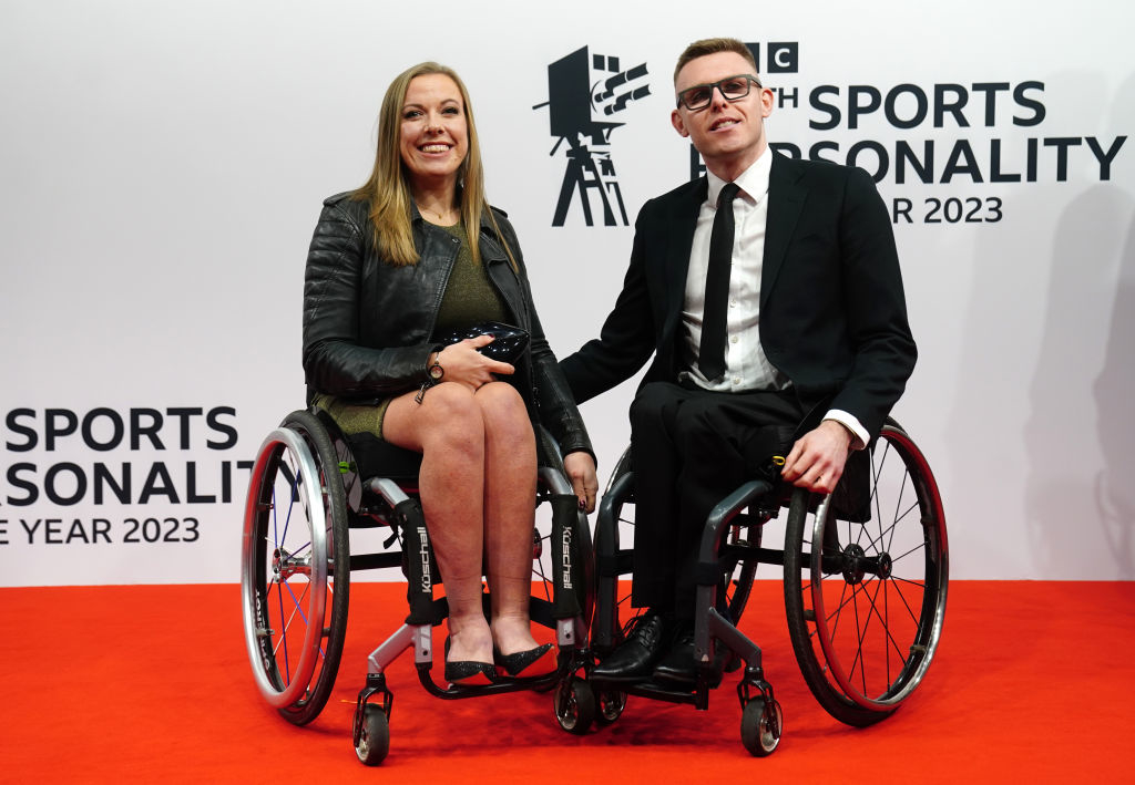 Hannah and Nathan at the BBC Sports Personality of the Year 2023, both in wheelchairs, dressed in formal attire, smiling on the red carpet