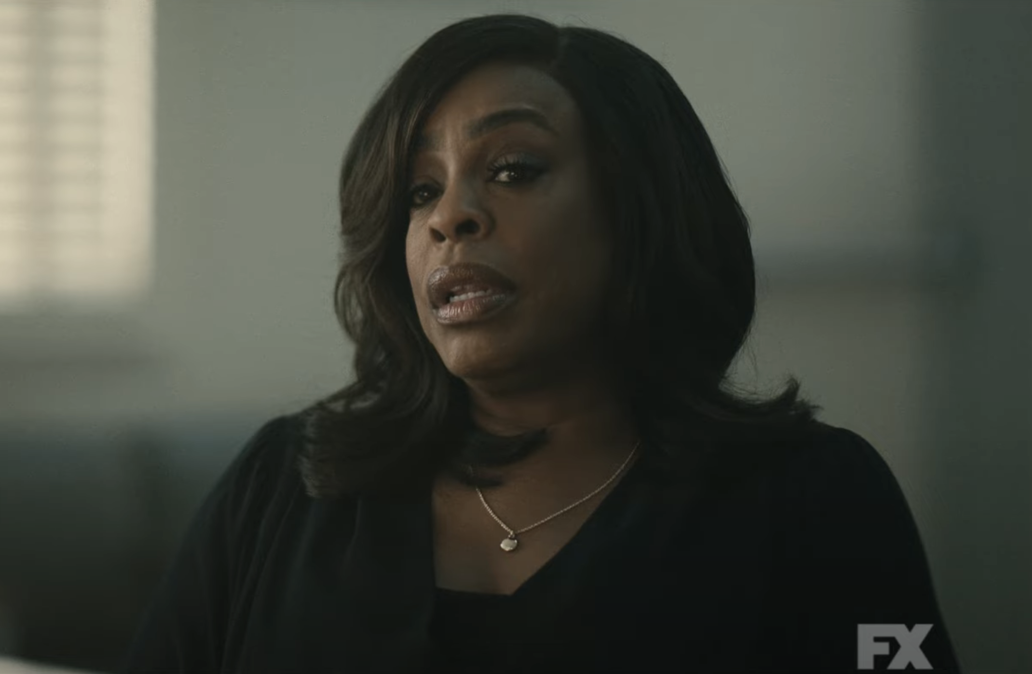 Niecy Nash in a scene from "Grotesquerie," wearing a dark outfit and a necklace
