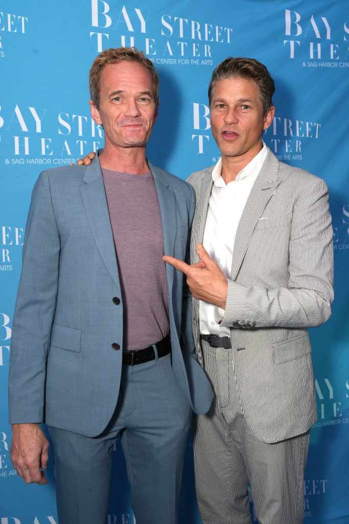 Neil Patrick Harris in a light blue suit and David Burtka in a gray pinstripe suit at the Bay Street Theater event