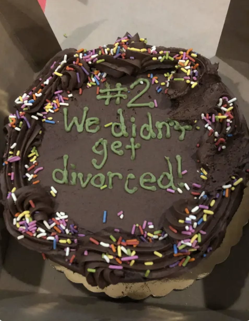 Chocolate cake with rainbow sprinkles, decorated with the text: "#2. We didn’t get divorced!"