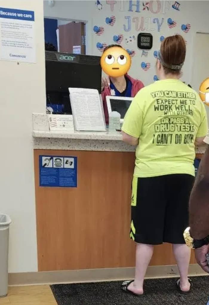 Customer at a service counter wearing a humorous shirt that says, "You can either expect me to work well with others or pass a drug test. I can't do both."